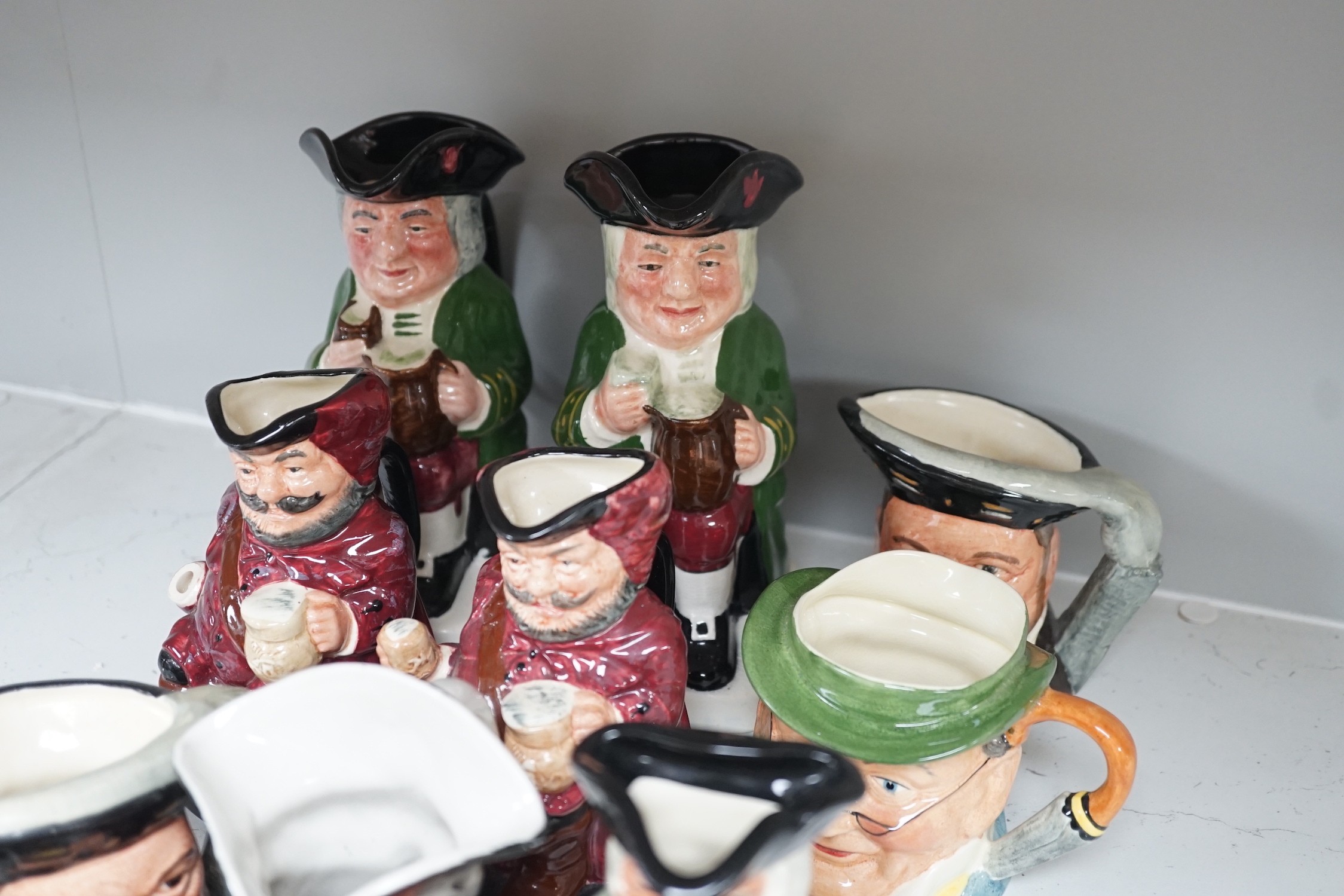 Five Royal Doulton toby jugs and a collection of similar toby jugs